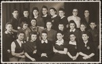 Group portrait of young women wearing Jewish badges, who worked in a sewing workshop in Bedzin.