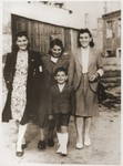 Members of the Oppenheim family pose outside in the Bedzin ghetto, wearing armbands.