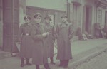 Two SS men gather with two other Germans on a street in the Lodz ghetto.
