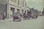 Horse-drawn carts go down a street in the Lodz ghetto.