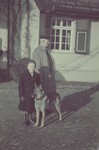 Mr. Meir, father-in-law of Hans Biebow, walks with one of the sons of Hans Biebow, outside their home in Bremen, Germany.