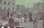 A market in the Lodz ghetto.  

Hans Biebow is pictured.