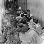 Female survivors inside a squalid barracks in Bergen-Belsen after liberation.