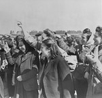 Female survivors greet British liberators in Bergen-Belsen.