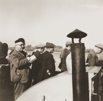 Jewish refugees from the Kladovo transport participate in a morning prayer service on the deck of a riverboat travelling from Kladovo to Sabac.