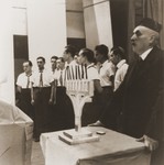 Members of the Kladovo transport lead a Hanukkah candlelighting ceremony at the Sabac refugee camp.