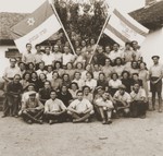 Members of the Brit Hanoar Hamizrahi from the Kladovo transport pose with the Zionist flag.