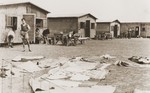 At a refugee camp established for members of the Kladovo transport, Zionist youth perform their daily tasks in front of their barracks.