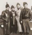 The leaders of the Kladovo transport stand on the deck of a riverboat docked in Kladovo harbor.