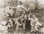 Group portrait of members of the Akiva Zionist youth group wearing armbands in the Wisnicz ghetto.