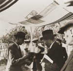 A Jewish refugee couple from the Kladovo transport are married outside under a chupa [canopy].