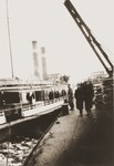 Jewish refugees from the Kladovo transport walk along a dock next to the Czar Nichola II riverboat.