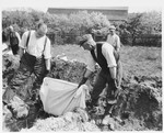 German civilians from Estedt remove the bodies of Polish, Russian and Jewish slave laborers from a mass grave for proper reburial.