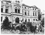 Under the direction of American soldiers, German civilians rebury the bodies of 71 political prisoners, exhumed from a mass grave near Solingen-Ohligs, in front of the city hall.