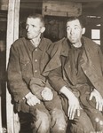 Two emaciated Soviet POWs sit on a bunk inside a barracks in the newly liberated Hemer POW camp.