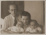 A Jewish DP couple poses with their infant twins.
