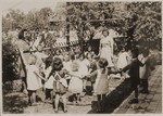 Children and their teachers play a circle game in the schoolyard at the Neu Freimann displaced persons camp.