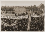 Jewish DPs at the Neu Freimann displaced persons camp carry Hebrew and Yiddish banners protesting British immigration policy to Palestine.