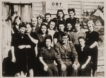 Group portrait of young Jewish DP women with their male instructor in front of an ORT (Organization for the Rehabilitation through Training) vocational training center in Germany.