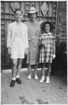 Peter Witting poses outside with his mother and sister.