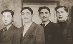 Four teenage boys wearing Jewish badges in Sosnowiec.