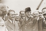 Nahum Goldmann, chairman of the executive council of the World Jewish Congress, is escorted through the Lampertheim displaced persons camp by Captain Abraham Hyman (center in uniform) and Mathilde Oftedal (left).