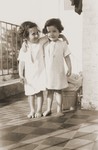 Two young girls stand on the balcony of the Home des Moineaux (AIVG)  in Uccle, Belgium

Pictured are Edith Richter and Jeannette Schindelheim (Oselka-Korn).
