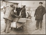 Residents of the ghetto move to new housing after the Germans reduced the borders of the Kovno ghetto.