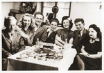 A group of young adults attends a birthday party for Irene (Freda) Landau in the Foehrenwald displaced persons camp.