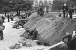 Polish civilians dig an anti-tank trench along a street in Warsaw to slow the advance of the German army.