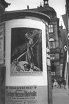 A poster advertising the Great Anti-Bolshevism Exhibition 1937 (Grosse Antibolschewistiche Ausstellung) is plastered on a kiosk on a city street in Nuremberg.