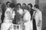 Women learn how to take care of an infant at a special school for teaching cooking and childcare to the wives of German political leaders in Berlin.
