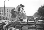 American photographer Julien Bryan films a scene during the siege of Warsaw.