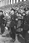 German SS troops stand in front of the crowd of saluting spectators at the 1937 Reichsparteitag (Reich Party Day) celebrations in Nuremberg.