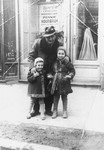 A Jewish man poses with his two nieces on a street in Rzeszow, Poland.