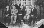 Group portrait of seven friends from Sejny. 

Pictured seated left to right are: Lejzer Szczupacki, Yakov Ostrov (a bank director), Moshe Mishkinski, Peretz, and Wolf Ostrov.