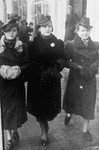 Three young Jewish women walk along a street in Radom.