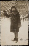 Zipporah (Katz) Sonenson stands in the snow holding onto a tree branch in Eisiskes.
