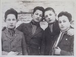 Four Jewish teenage boys from Eisiskes pose wearing striped cravats, indicating they were members of the soccer team.
