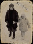 A Jewish brother and sister walk in the snow in Eisiskes.