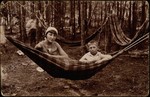 A Jewish brother and sister sit in a hammock while vacationing in Dumbla, a summer resort in Eisiskes.