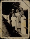 Moshe and Zipporah Sonenson pose with their children, Yitzhak and Yaffa, on a bridge in the Tetlance Forest.