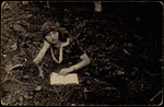 Zipporah Katz (Sonenson), one of the shtetl Hebrew librarians, reads a book while lying in a field.