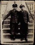 In honor of their bar mitzvah, two best friends, Avigdor Katz (left) and Avremele Botwinik, pose for a photo on the steps leading to Avigdor's house which also served as the pharmacy and photo studio of his mother Alte Katz.