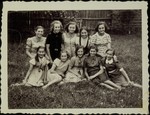 A group of young girls pose in a yard in the town of Eisiskes.