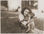A small Spanish girl and a dog at the Recebedou camp.
