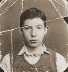 Damaged photograph of Dov Levin, a Jewish school boy in pre-war Kovno, that was preserved through the war by a friend in the sole of her shoe.