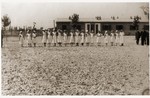 Nurses and guards gather in front of the management of the Recebedou camp.