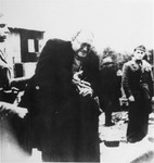 A Jewish prisoner is forced to remove his ring upon his arrival in the Jasenovac concentration camp.