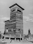 An Ustasa guard stands next to a watch tower in the Jasenovac concentration camp.
